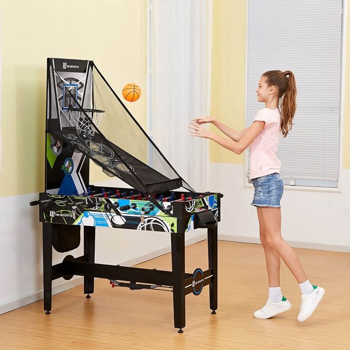 Retailer lifestyle photo: a girl tossing a basketball at the hoop attachment in a yellow room